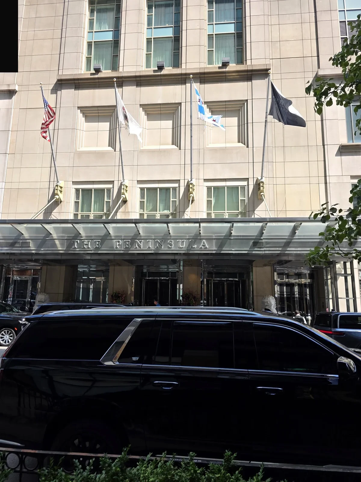 Black Cadillac Escalade parked at the entrance of The Peninsula Chicago