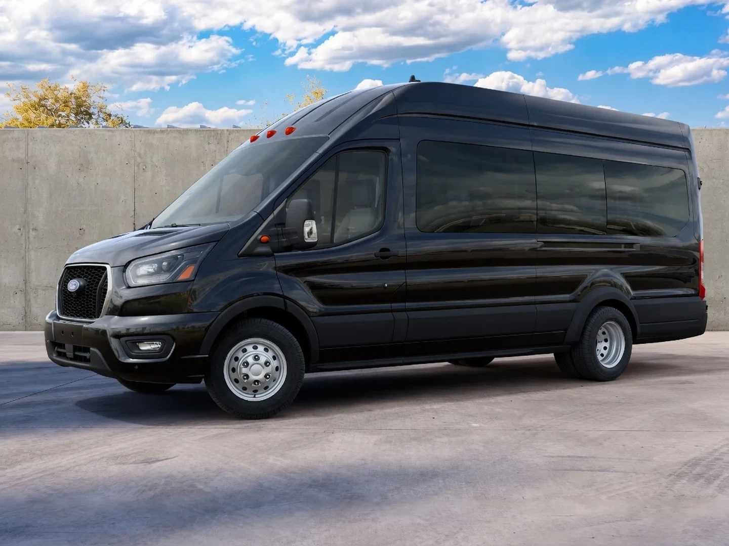 Black Ford Transit passenger van parked in daylight