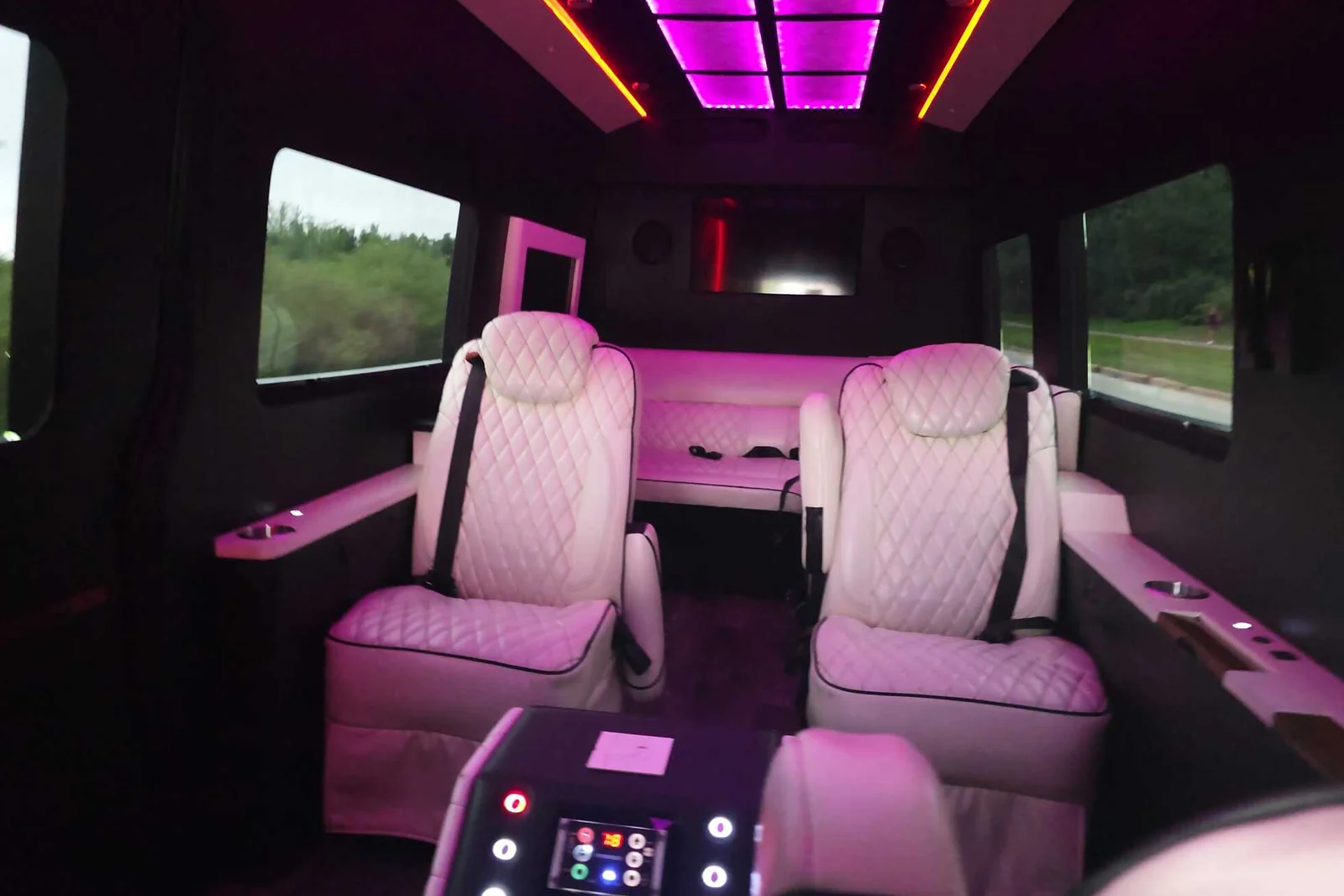 Jet Sprinter Limo interior with pink LED lighting and white quilted captain's seats - Meridian Fleet Chicago