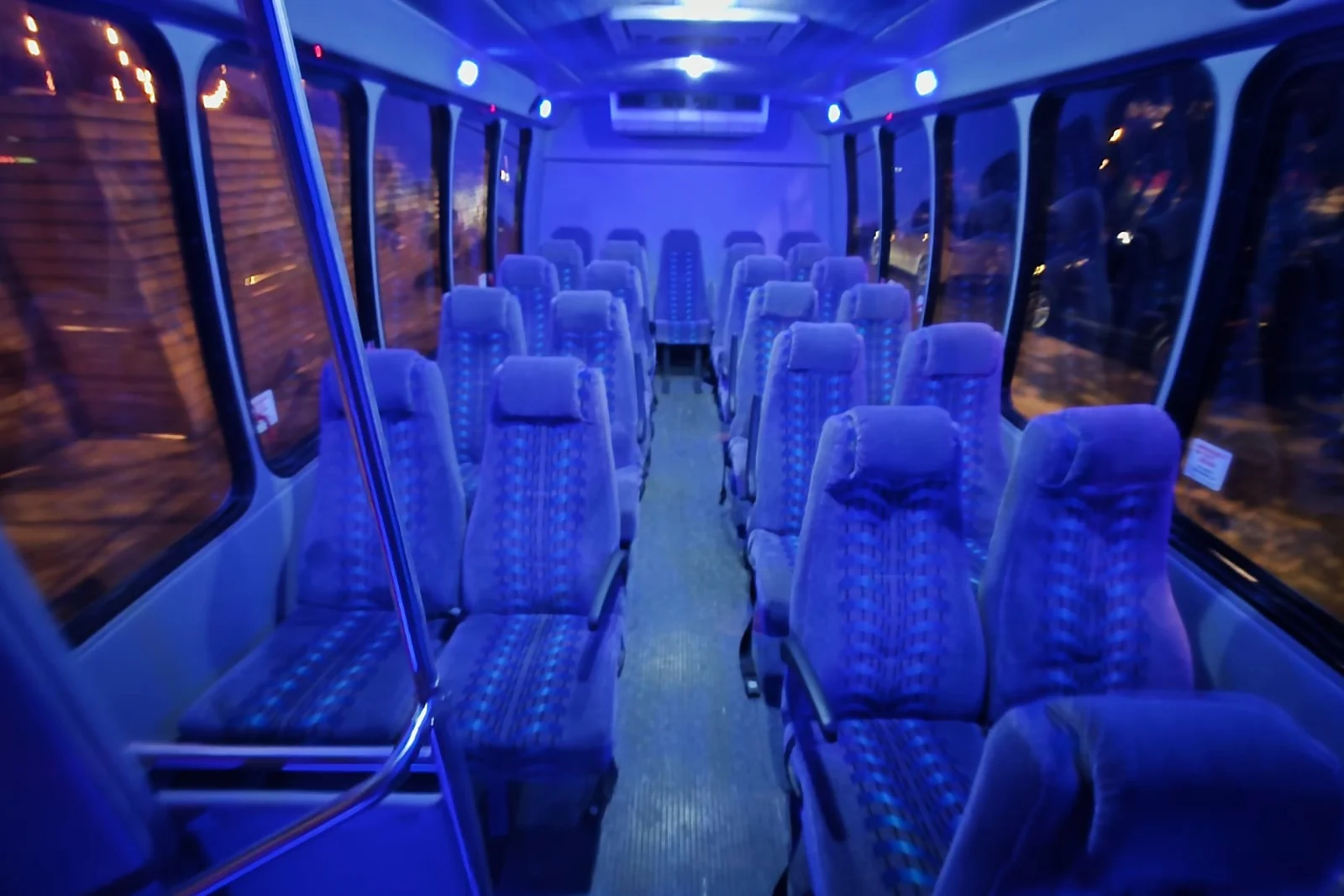 Mini bus interior rows of forward-facing cloth seats
